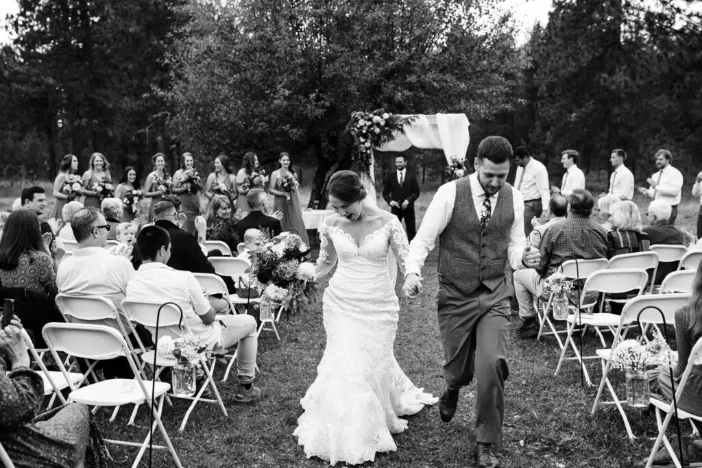 Montana Wedding Photographers Capture Couple Running Down The Isle
