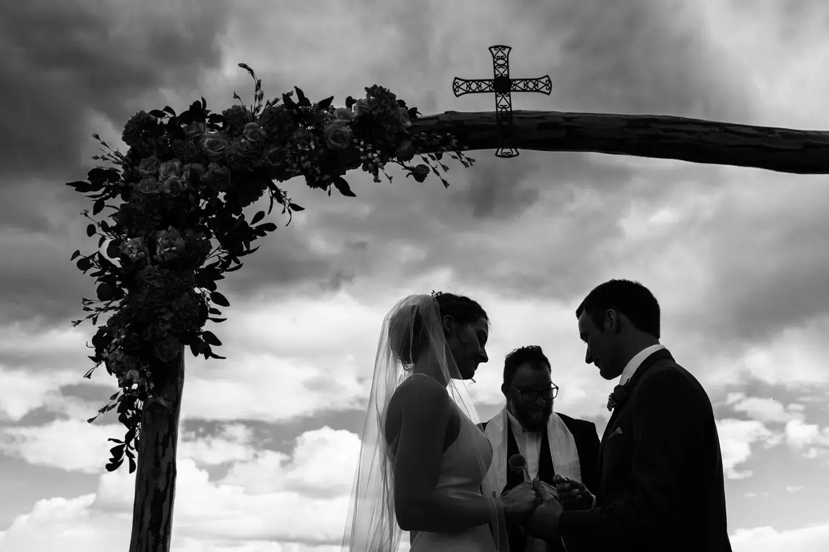 What To Do If It Rains On Your Wedding Day. Couple At Ceremony Just Before A Storm